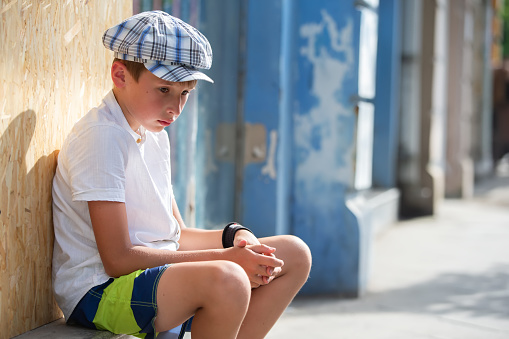 Sad pensive little boy outdoors. Psychological portrait of a pensive child.