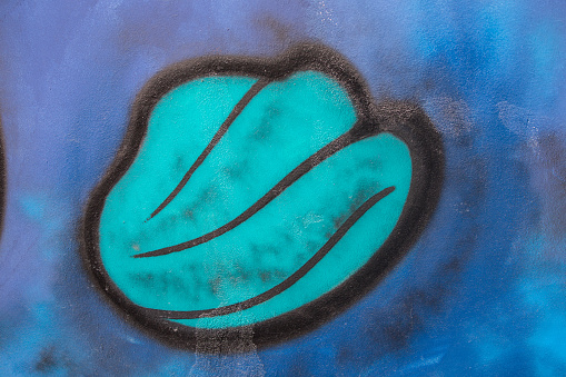 Abstract blue graffiti with green blot.
