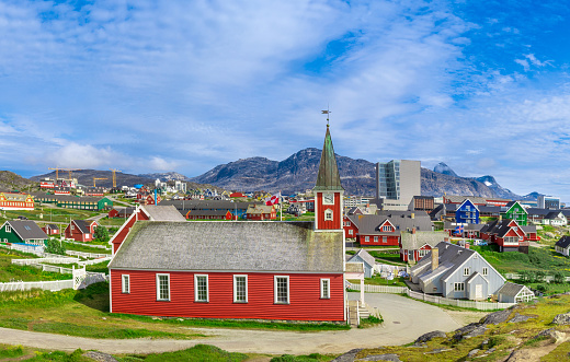 Typical architecture of Greenland capital Nuuk with colored houses located near fjords and icebergs.