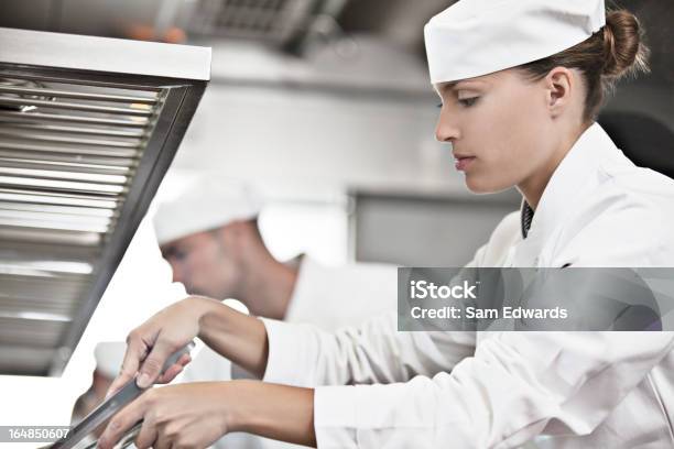 Chef Cooking In Restaurant Kitchen Stock Photo - Download Image Now - Profile View, People, Restaurant