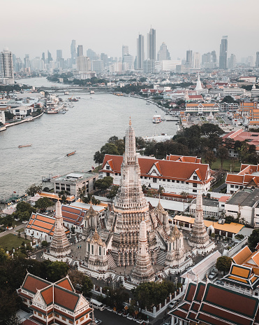 Wat Arun in Bangkok with Bangkok skyline in background