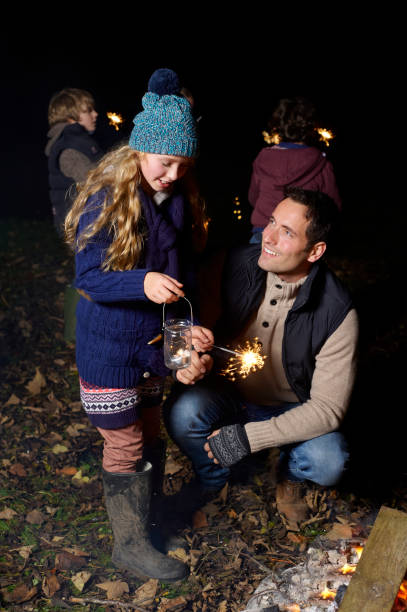 istock Father and daughter playing with sparkler 164851108