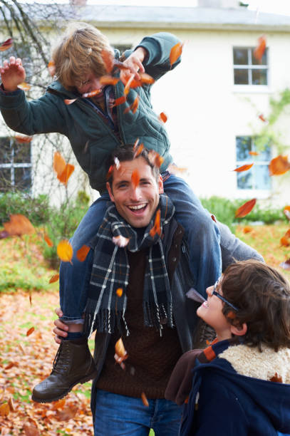 istock Father and son playing in autumn leaves 164851228