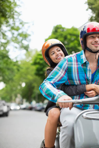 istock Couple riding scooter together 164851707
