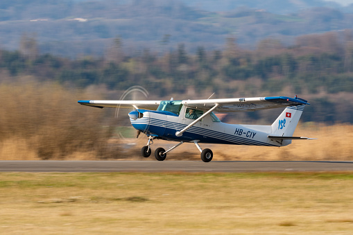 Wangen-Lachen, Switzerland, March 27, 2022 Cessna 152 propeller plane is taking off from a small airfield