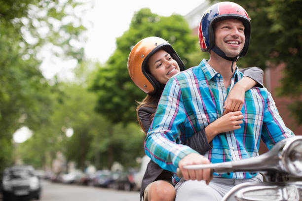 istock Couple riding scooter together outdoors 164851949