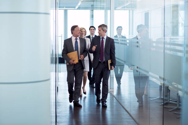 istock Businesspeople walking in hallway 164852313