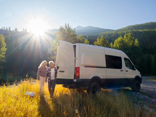 istock Mature couple leave camper van with picnic cooler 1648523261