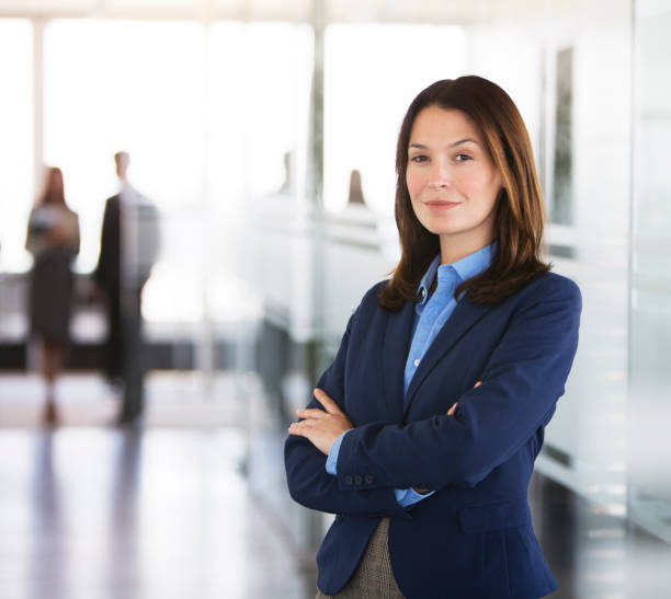 istock Businesswoman standing in office hallway 164852376