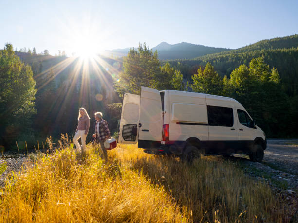 istock Mature couple leave camper van with picnic cooler 1648523796