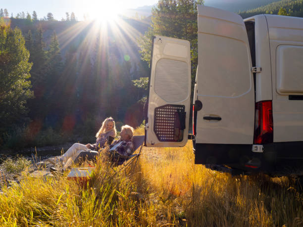 istock Mature couple relax beside camper van 1648523808