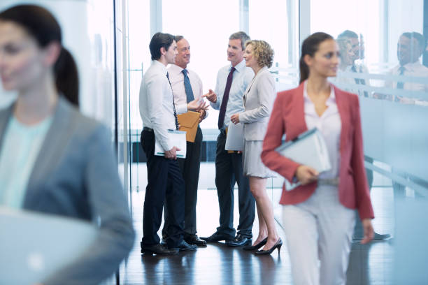 istock Business people talking in office hallway 164852517