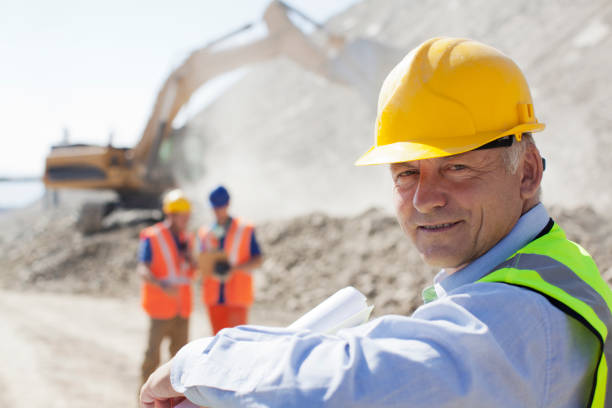 Businessman wearing hard hat in quarry  lean construction management stock pictures, royalty-free photos & images