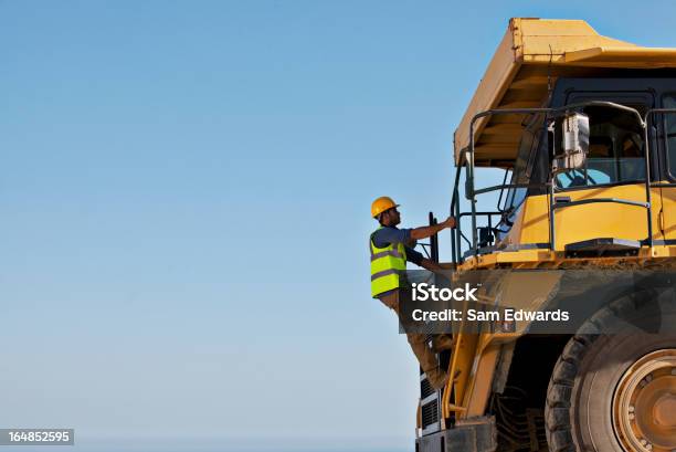 Worker Climbing Machinery On Site Stock Photo - Download Image Now - Construction Site, Construction Worker, Construction Machinery