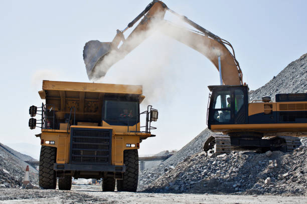 istock Digger and truck working in quarry 164852694