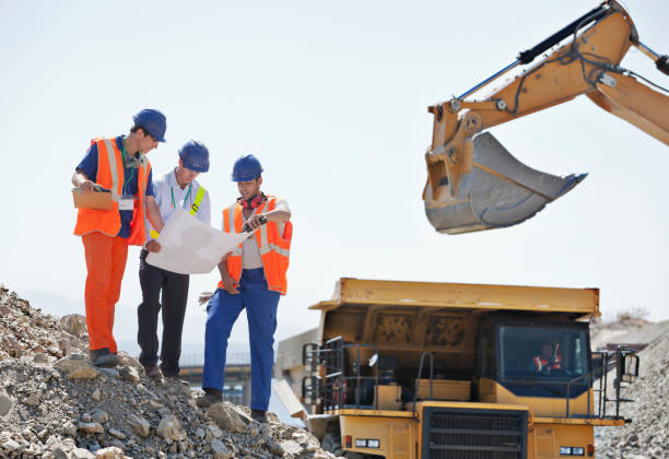 istock Workers and businessman reading blueprints in quarry 164852696