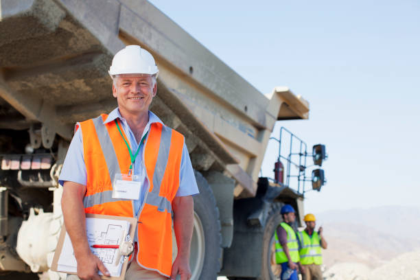 istock Businessman standing by truck on site 164852729