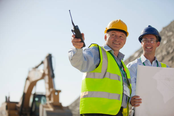 two men with hard hats on a construction site