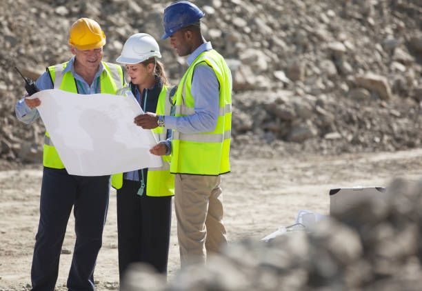 Business people reading blueprints in quarry  construction worker stock pictures, royalty-free photos & images