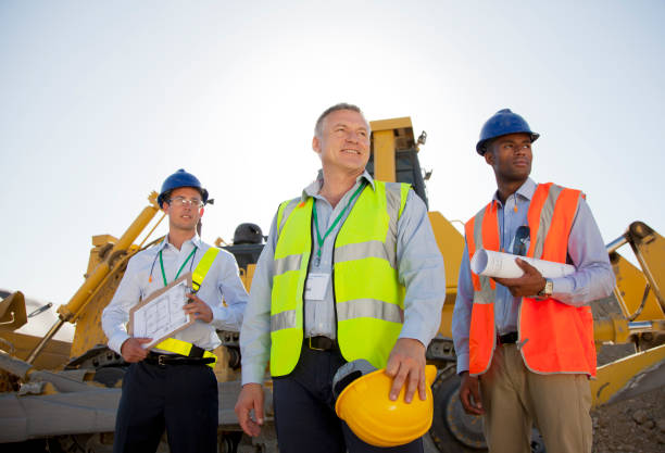 istock Businessmen in hard hats standing on site 164852824