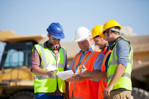 istock Workers and businessman talking in quarry 164852861