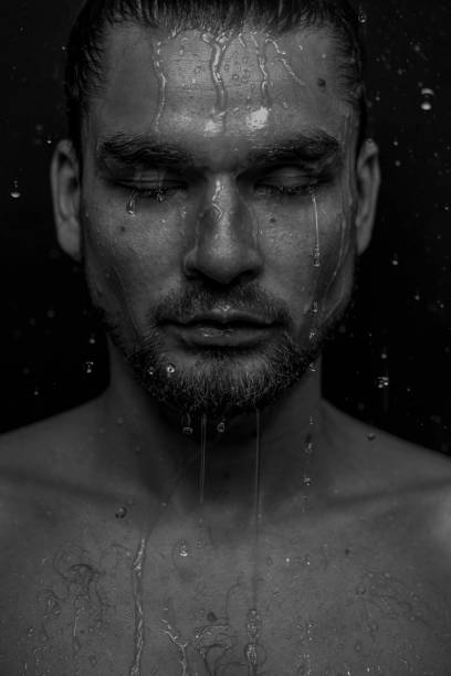 istock Beautiful male studio portrait with water 1648529898