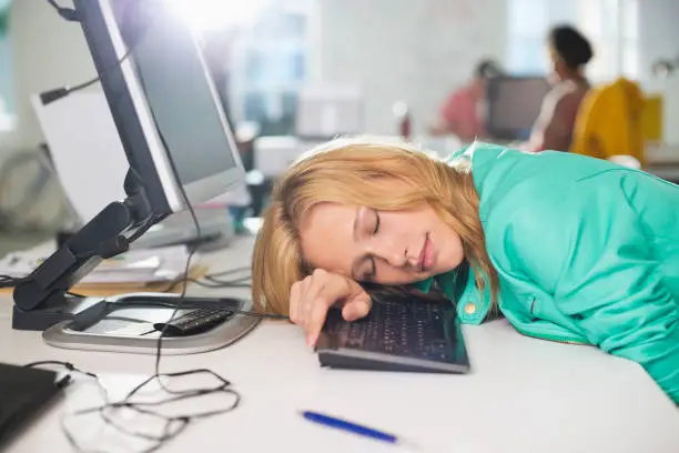 Photo of Businesswoman sleeping at desk