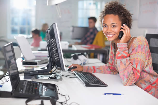 Businesswoman talking on phone at desk  cordless phone stock pictures, royalty-free photos & images