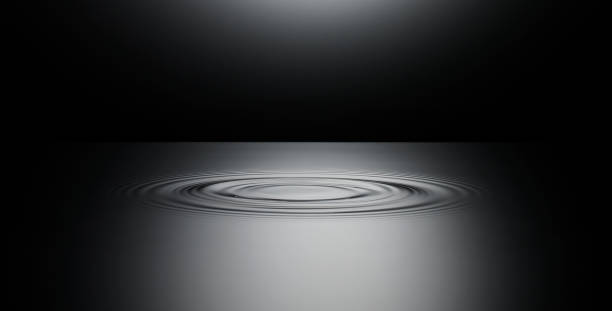 Ripple in surface of still water water on black surface stock pictures, royalty-free photos & images
