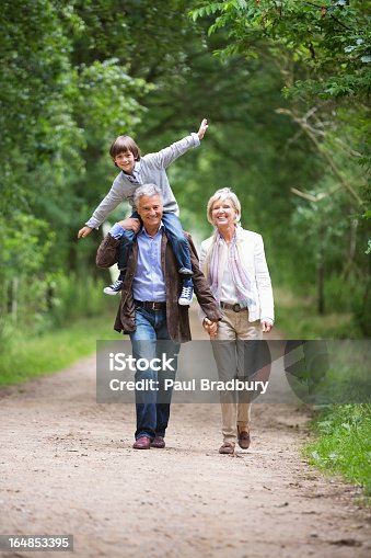 istock Couple walking with grandson on rural road 164853395