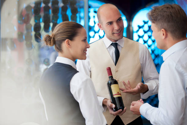 istock Waiters discussing bottle of wine in restaurant 164853972