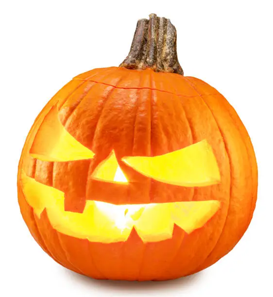 Carved pumpkin for Halloween jack-o'-lanterns with scary smiles and burning candle inside on white background. Clipping path.