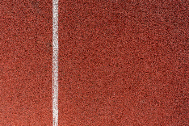 istock Running track surface on a track and field athletics stadium. 1648543798