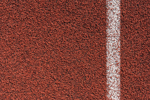 istock Running track surface on a track and field athletics stadium. 1648544325