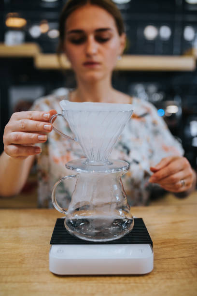 istock Barista girl prepares coffee through a cone filter 1648544912