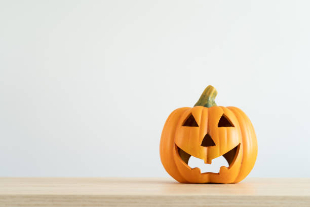 istock Halloween pumpkin decoration. Decorative spooky Jack-o'-lantern. Decorating house for Halloween. Composition with copy space. 1648548793