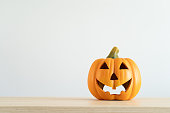 Halloween pumpkin decoration. Decorative spooky Jack-o'-lantern. Decorating house for Halloween. Composition with copy space.