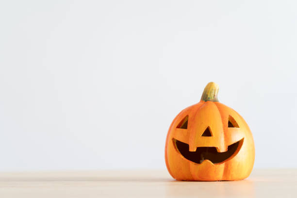 istock Halloween pumpkin decoration. Decorative spooky Jack-o'-lantern. Decorating house for Halloween. Composition with copy space. 1648548849