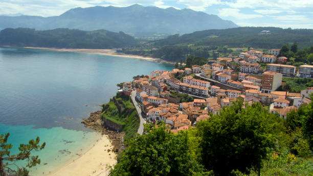 istock Bay and beach with pretty coastal town 1648563725