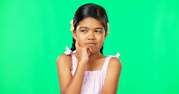 istock Thinking, green screen and idea by child with a question feeling excited, thoughtful and isolated in studio background. Planning, girl and joyful kid is happy, curious and planning expression 1648577081