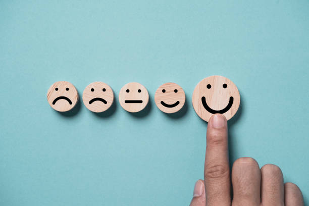 istock Hand touching to smile face on blue background for positive thinking and excellent evaluation after use product and service concept. 1648579891