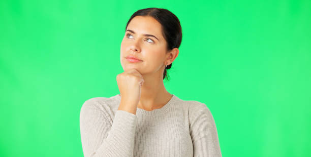 istock Face, thinking and option with a woman on a green screen background in studio to consider a decision. Idea, mind and contemplating with an attractive young female looking thoughtful on chromakey 1648588781