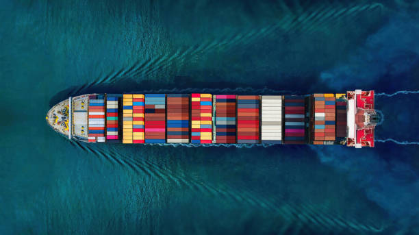 istock Industrial import-export port prepare to load containers. Aerial top view container ship in export and import global business and logistic. Global transportation and logistic business. 1648589264