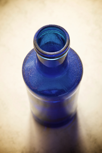 Blue glass bottle on a table.