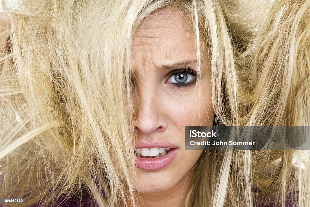 Woman having a bad hair day Woman with an aggravated expression and tangled hair for a bad hair day concept 20-24 Years Stock Photo
