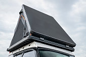 open tent on a roof of SUV, car camping concept