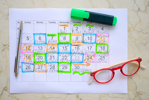 Calendar with business appointments,pen and spectacles, monthly schedule. Business concept,beat the clock.