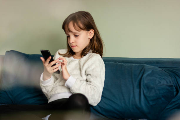 istock Girl looking at mobile phone 1648624748