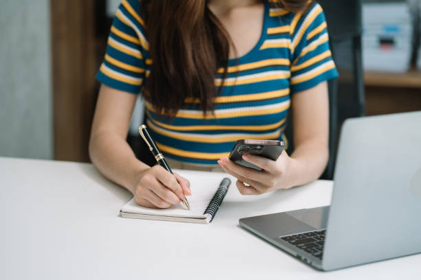 istock Learning online working concept. Businesswoman working on tablet and laptop computer, searching working in office. 1648635319