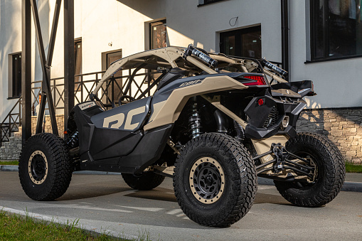 Novosibirsk, Russia - August 29 , 2023: black new ATV, rear view, for off-road driving on a warm summer day